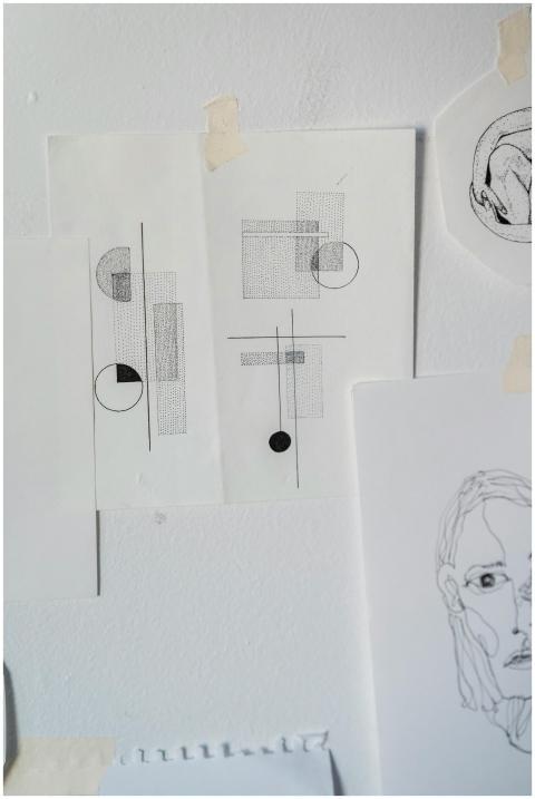 Minimalist abstract drawings and sketches taped to