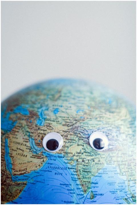 Model of globe with googly eyes representing Earth