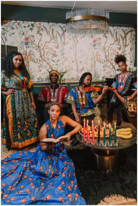 Diverse group celebrating Kwanzaa with traditional