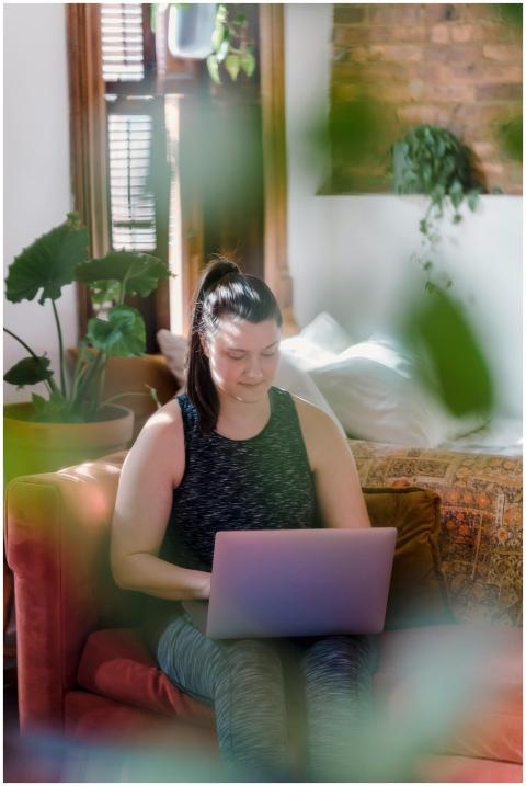 Woman in casual wear working on a laptop from a co