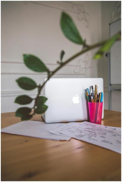 A clean, minimalist office desk setup with a lapto
