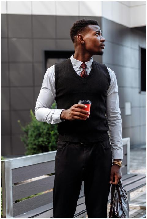 Confident businessman in smart attire holding coff