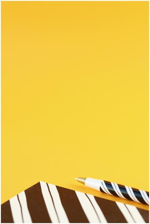 Minimalist composition with notebook and pen on vi