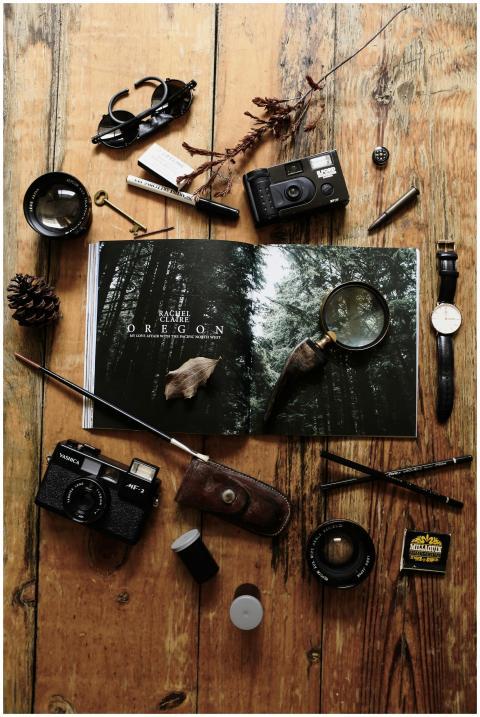 Flat lay of vintage photography gear and an open m