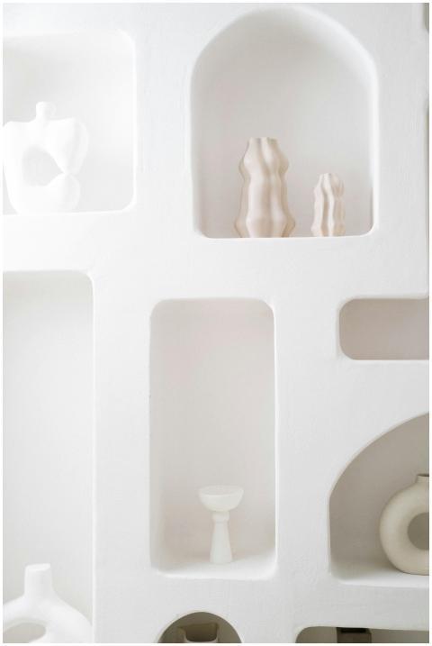 Calming white shelves displaying minimalist cerami