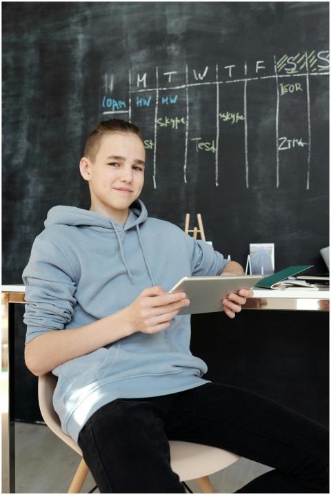 Teen studying with tablet in a modern home classro