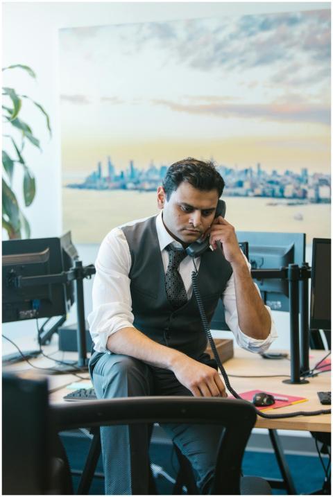 Focused businessman in office attire talks on land