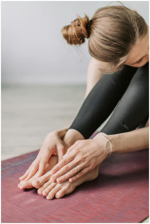 Close-up of woman in black sportswear doing yoga s