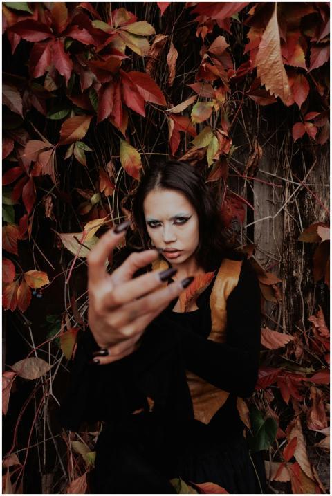 Portrait of a woman posing dramatically against a