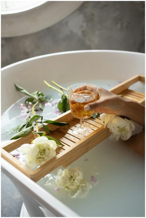 Serene bathtub scene with flowers, aromatherapy, a