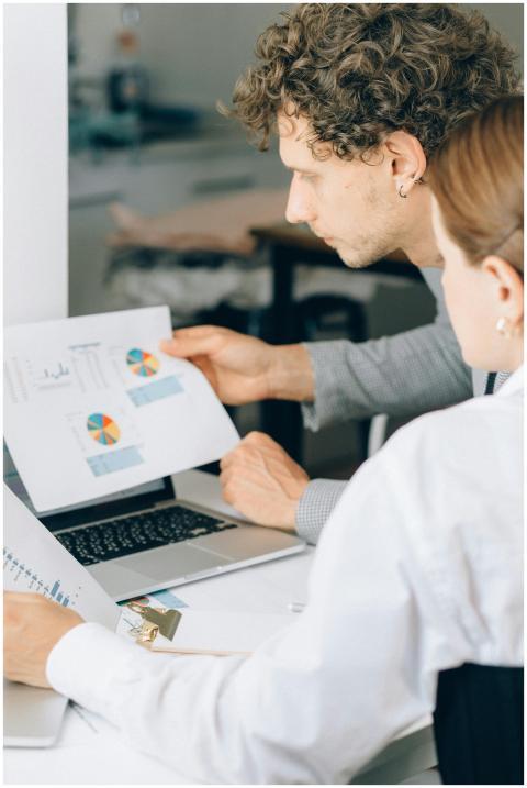 Two business professionals reviewing financial cha