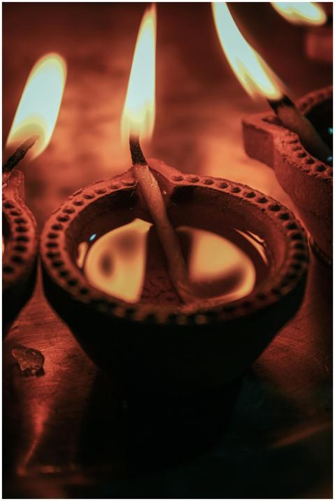 A close-up view of burning oil lamps, capturing th