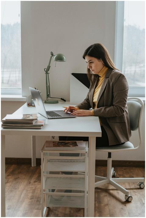 Businesswoman focused on her laptop in a modern of