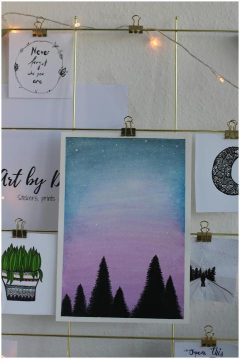 Artistic wall display featuring creative paintings