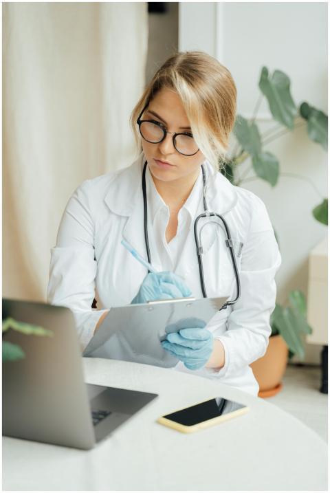 Caucasian female doctor in office attire taking no