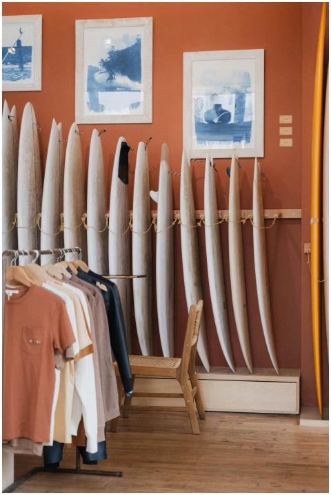 Cozy surf shop with surfboards and colorful clothi