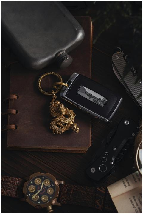 Elegant rustic arrangement of car key, dragon pend