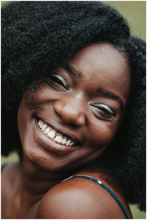 Happy adult African American female with perfect s