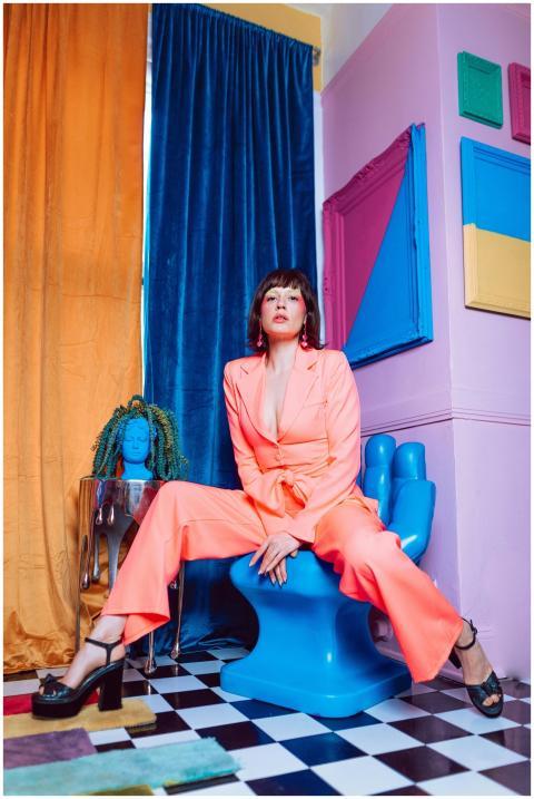 Bold fashion portrait of a woman in a colorful, ec