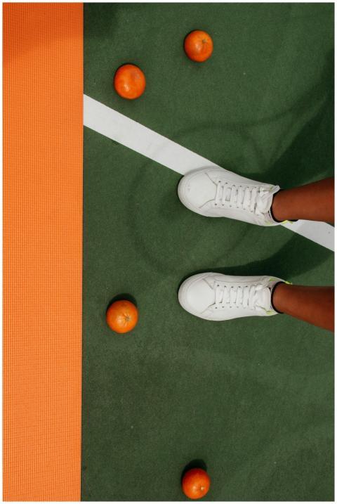 White sneakers on a tennis court with scattered or