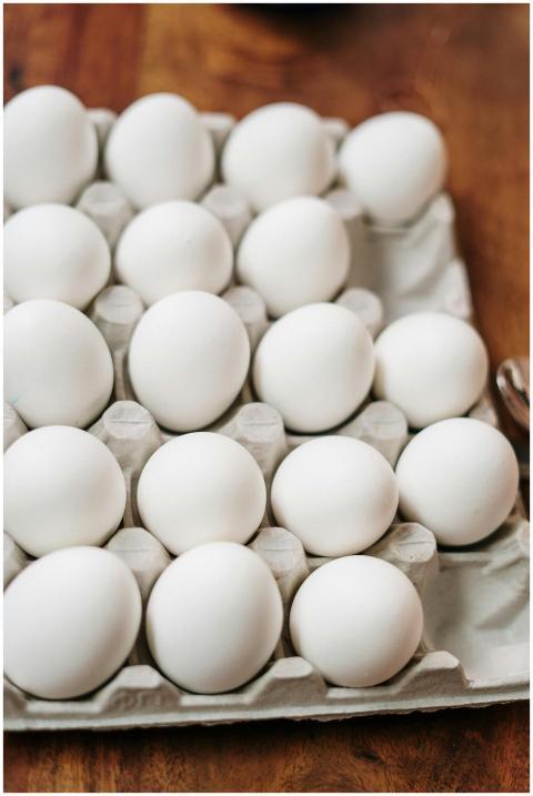A carton of fresh organic white eggs displayed on