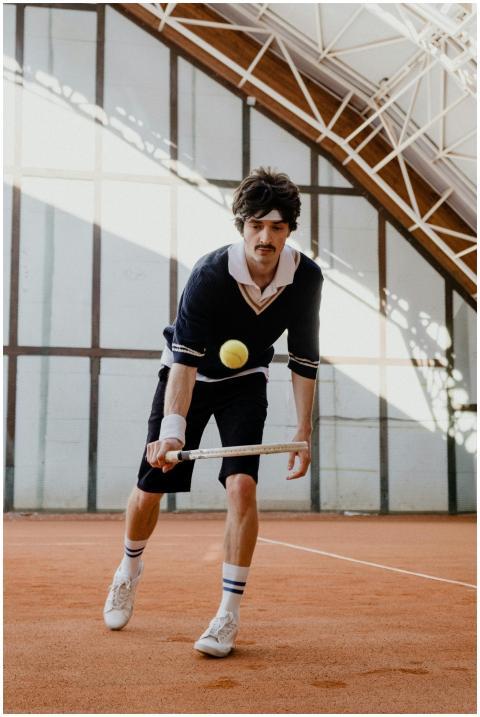 A male tennis player with a vintage style outfit i