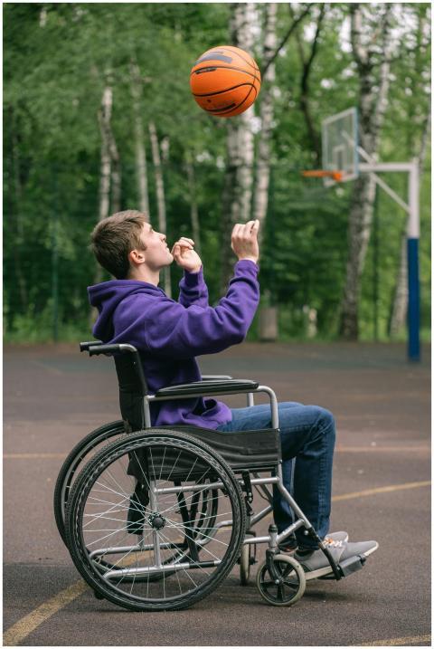A young man in a purple hoodie plays basketball fr