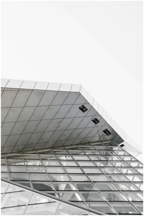 A low angle view of a modern building with glass p