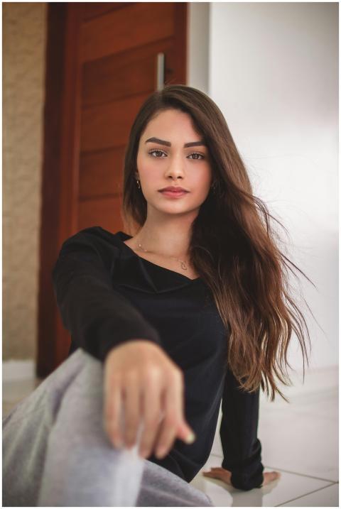 Portrait of a graceful brunette woman with long ha