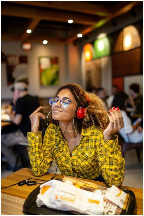 A stylish young woman with headphones enjoying mus