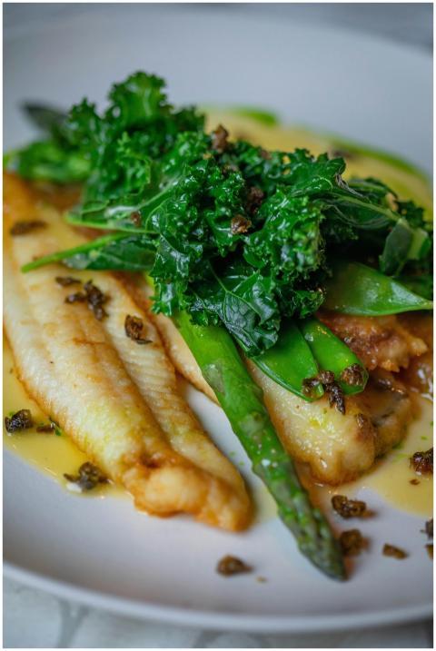 Close-up of a roasted fish fillet topped with aspa