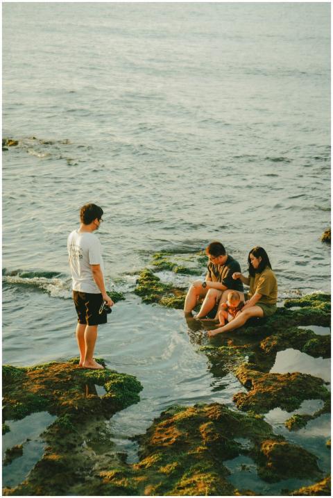 A group of friends enjoy the ocean view sitting on
