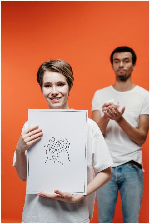 Two young adults demonstrating hand washing techni