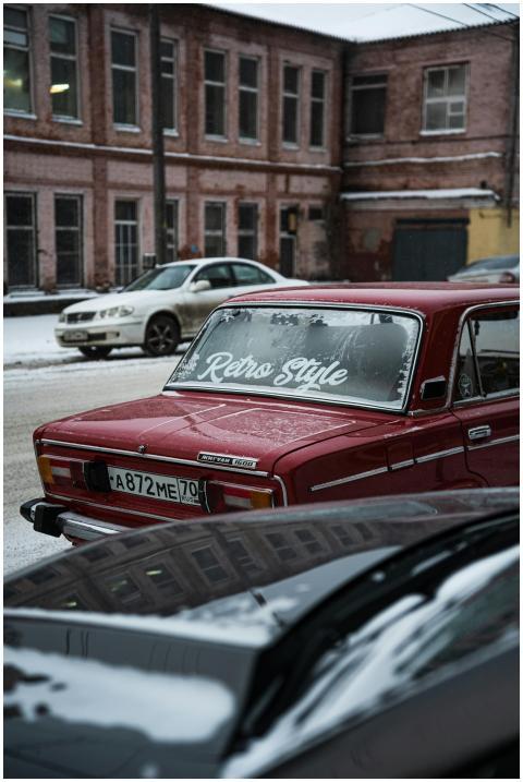 Vintage red car with 'Retro Style' on windshield p
