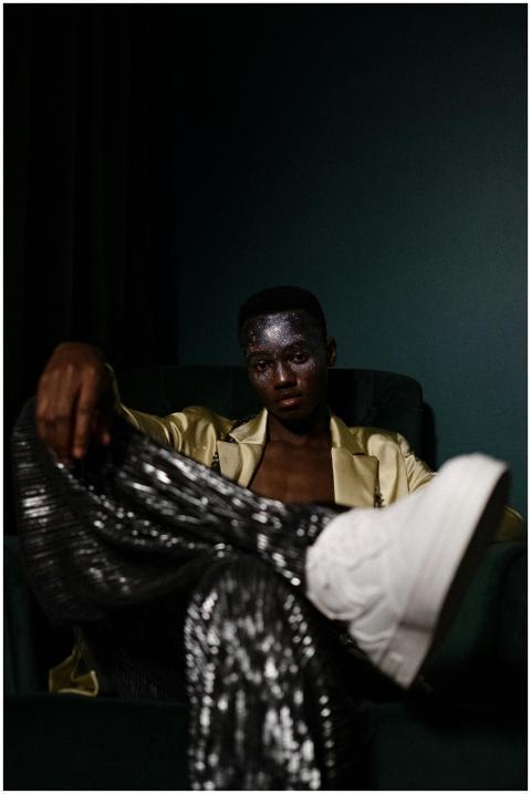 Glamorous indoor portrait of a man with glitter fa