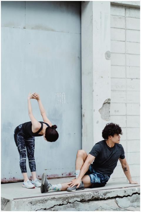 A man and woman performing stretching exercises in