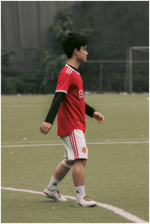 A young male athlete plays soccer on a field in Ha
