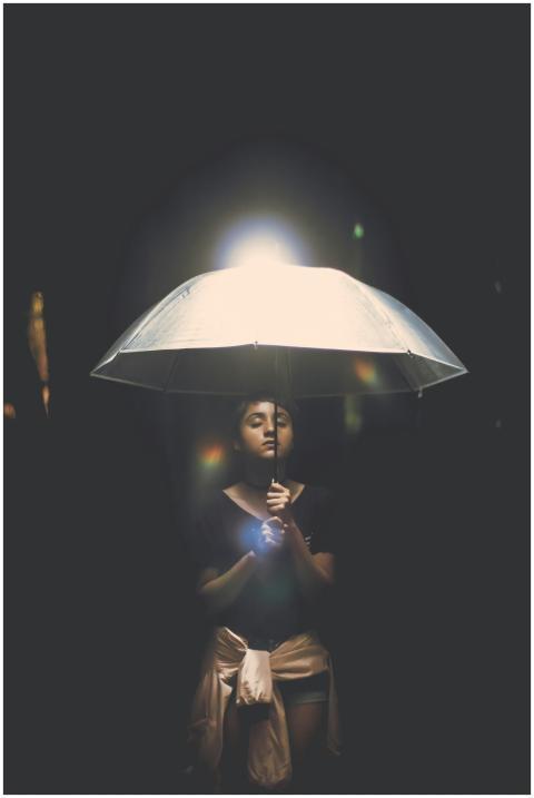 Elegant portrait capturing a young woman under a g