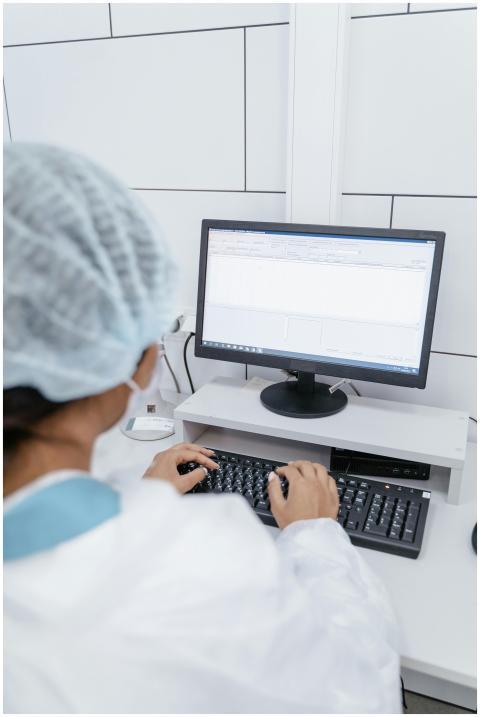A medical professional working on a computer in a