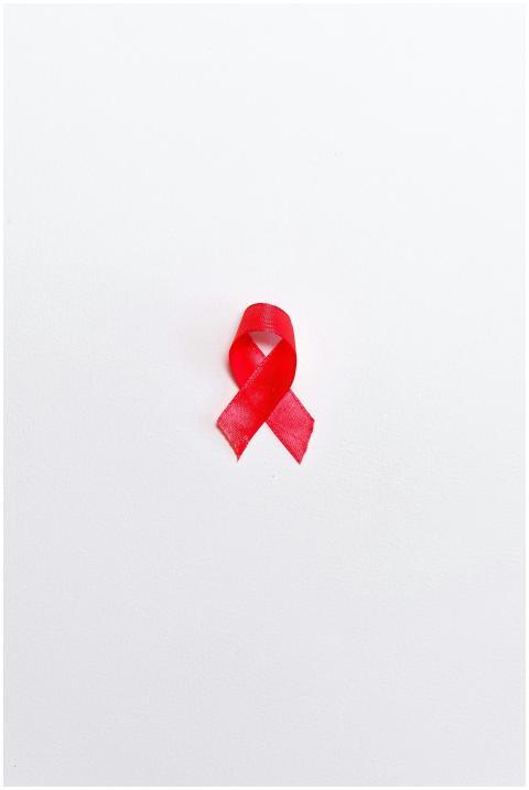A vibrant red ribbon on a white background represe