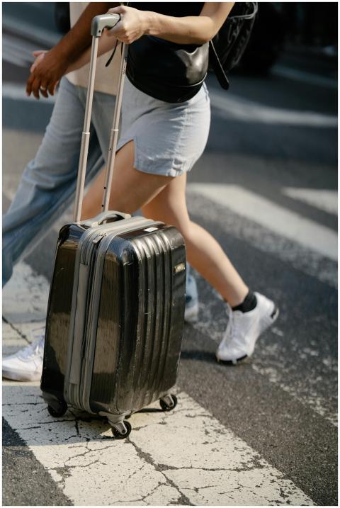 A couple walks together across a zebra crossing, c