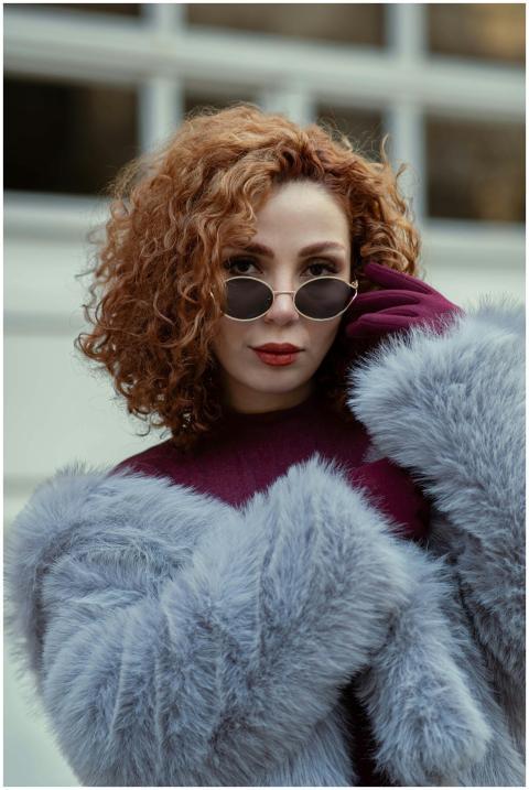 Stylish woman in sunglasses and faux fur coat, bal