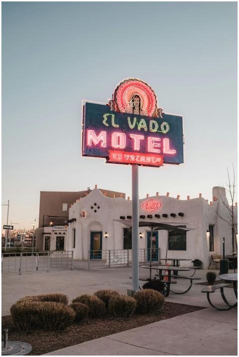 Neon-lit El Vado Motel sign against a clear evenin