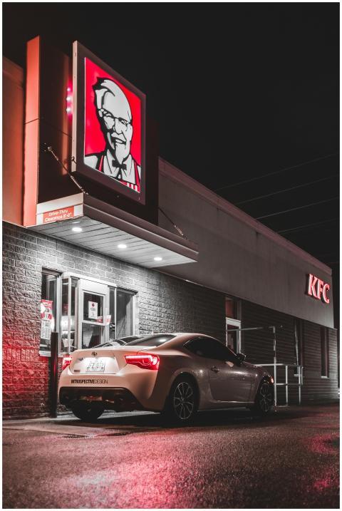 White car at window of cafe drive through ordering