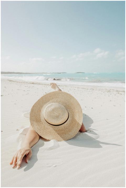 Anonymous female traveler in straw sunhat relaxing