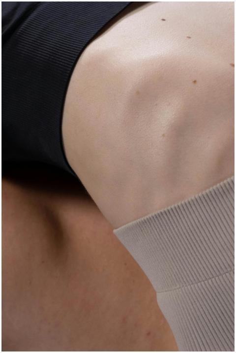 Detailed close-up of a woman's knee wearing sports