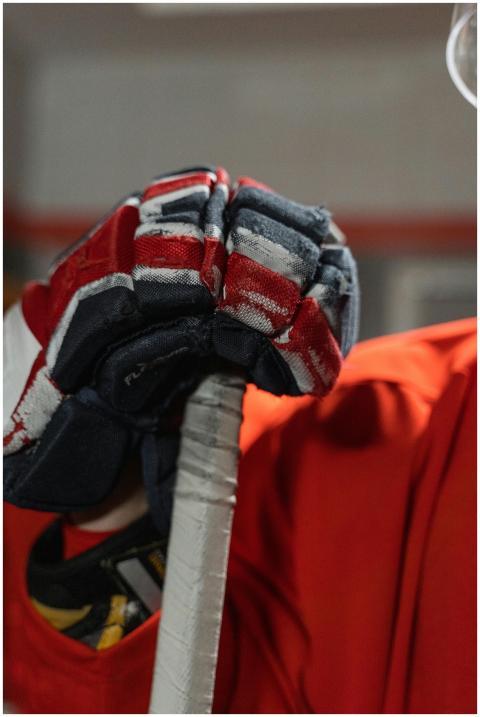 Vibrant close-up of a hockey glove gripping a stic