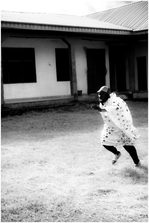 A person running outdoors in black and white, capt