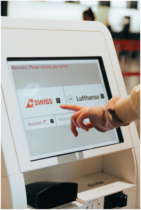 Hand interacting with airport kiosk for airline se