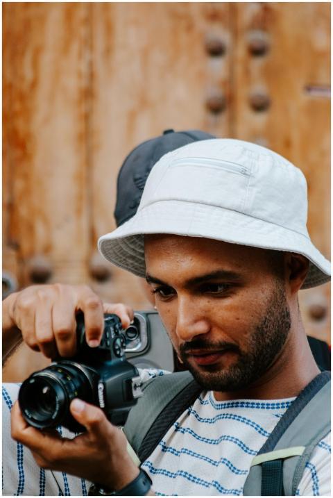 A man capturing street scenes in Rabat, Morocco, w